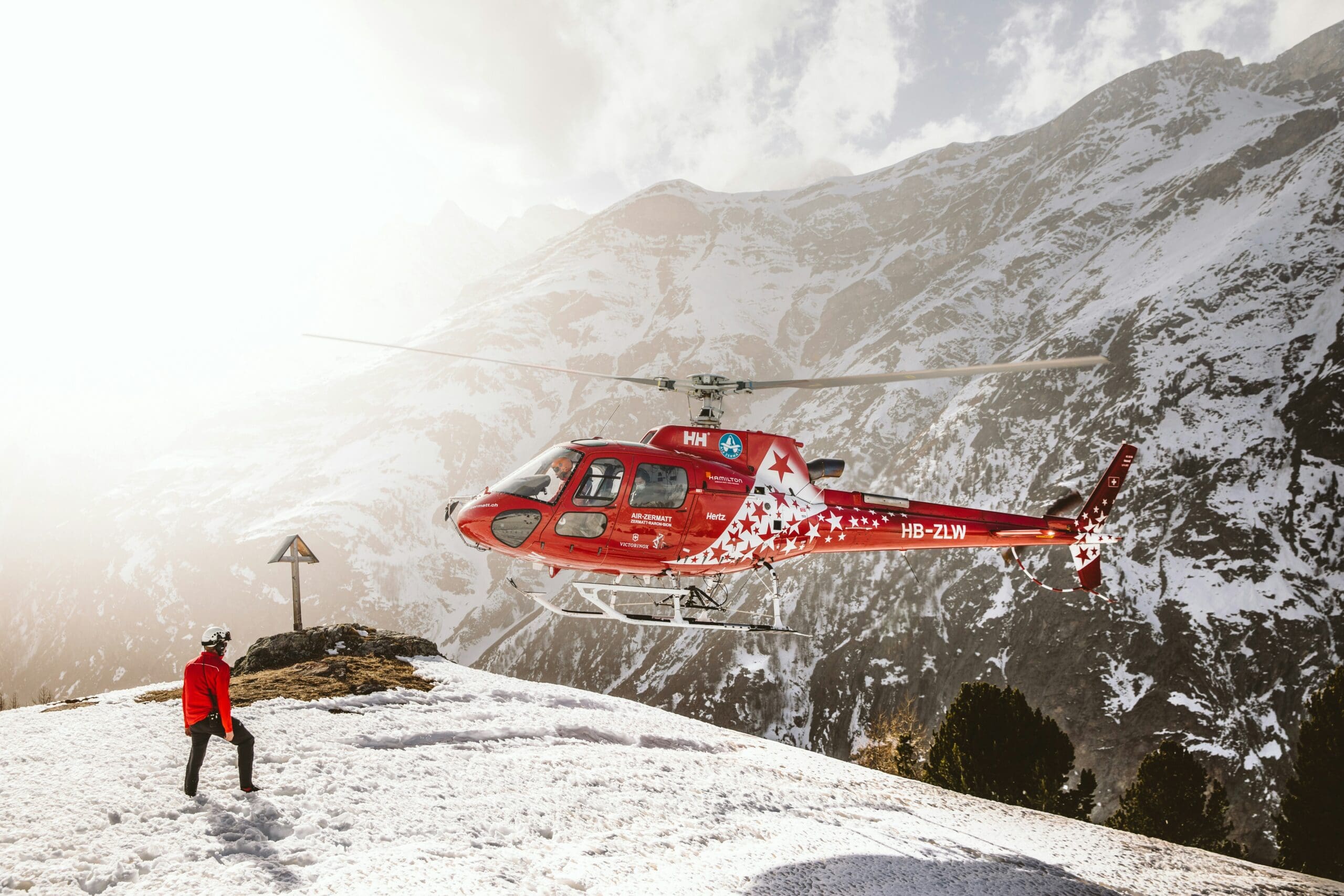 Rettungshubschrauber bei Bergung nach einem Unfall in den Bergen – Absicherung durch private Unfallversicherung bei Freizeit- und Sportunfällen.